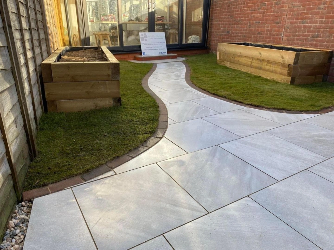 Curved garden path with turf and raised sleeper planters by Axtell Landscaping